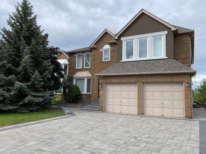 Before: dated beige builder garage doors
