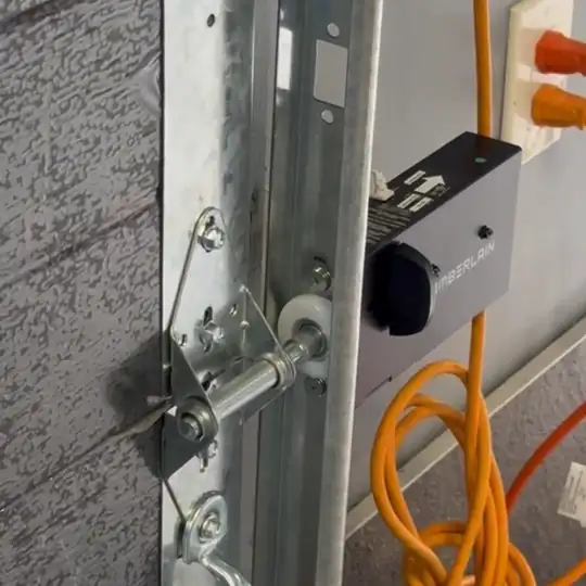Automatic lock bolt sliding into the garage door track to lock the door