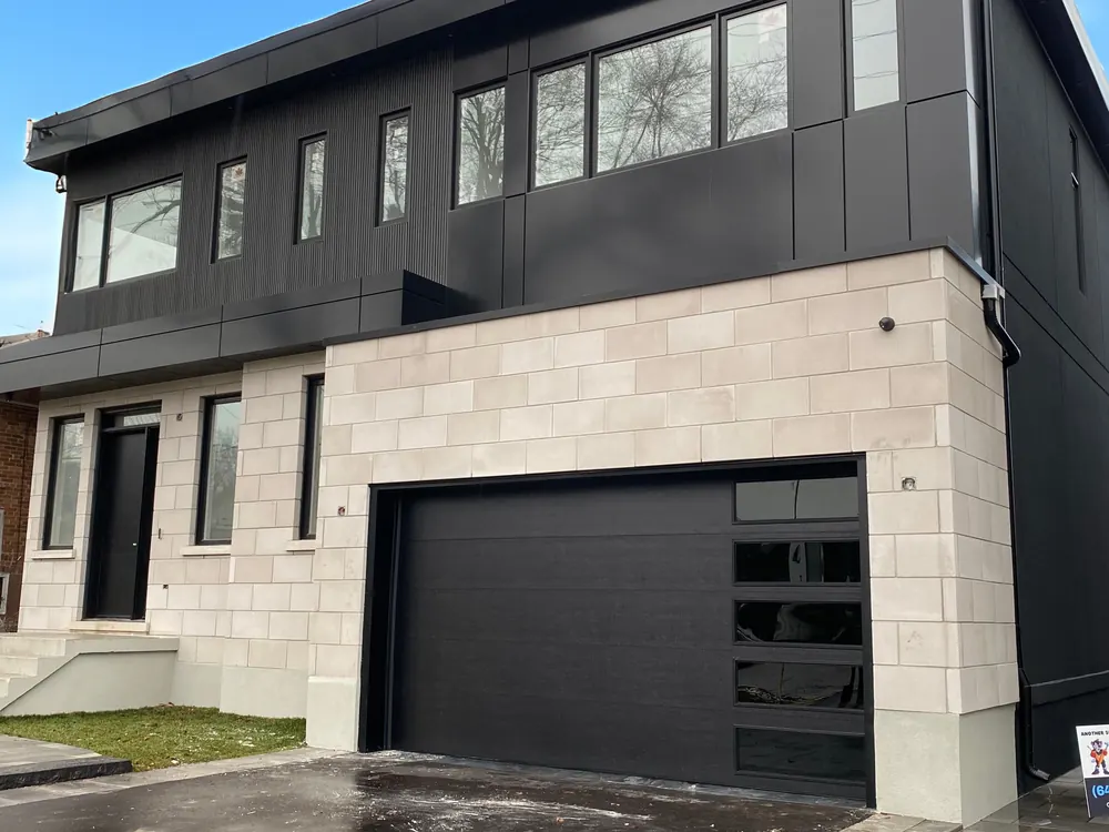 Black modern flush garage door with windows on a home in Aurora