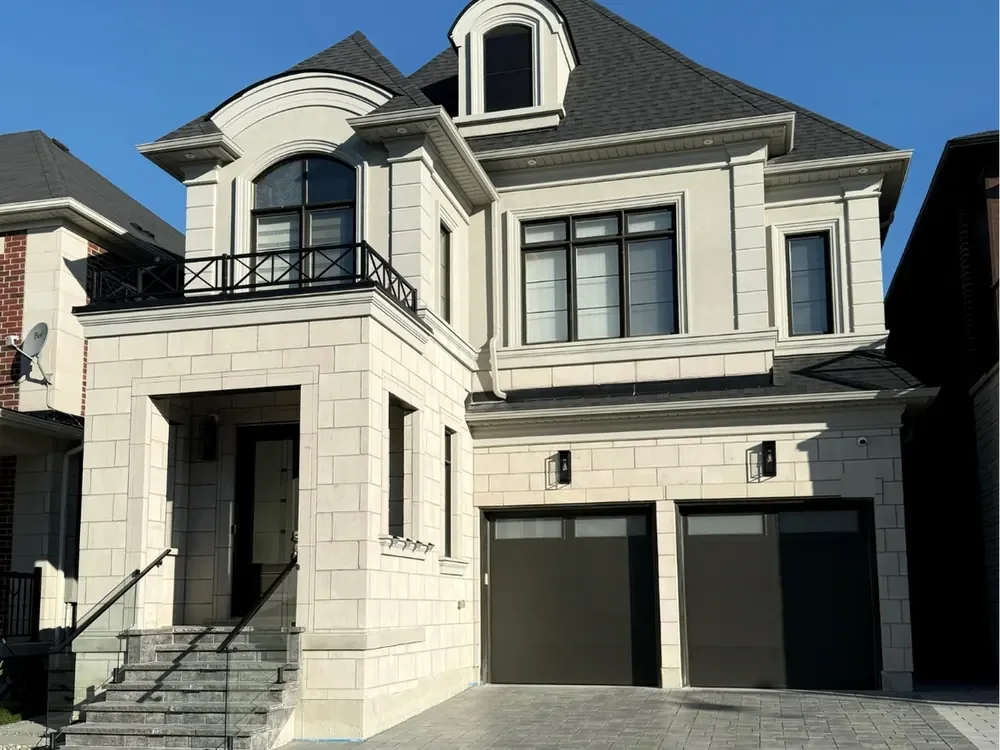 Black modern flush garage doors with windows on a home in Bradford