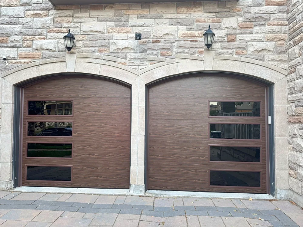 Woodgrain modern flush garage doors with windows on a home in Brampton