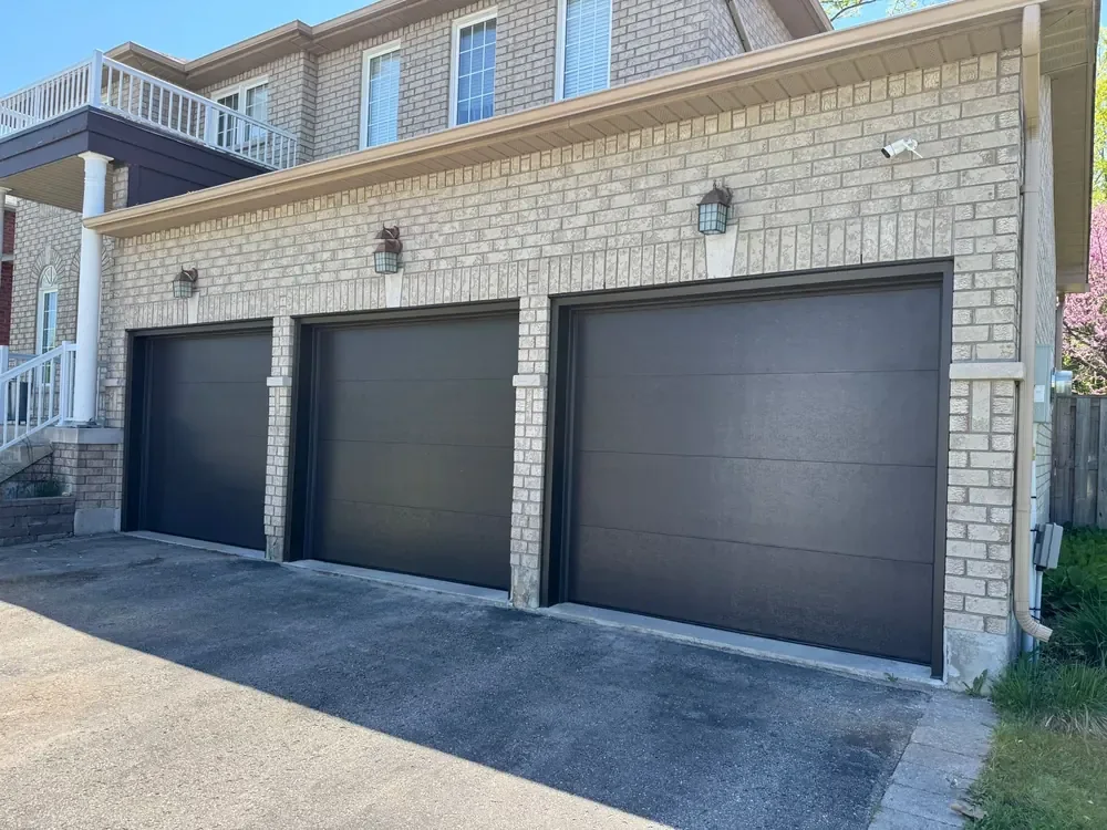 Black modern flush garage doors on a home in Stouffville