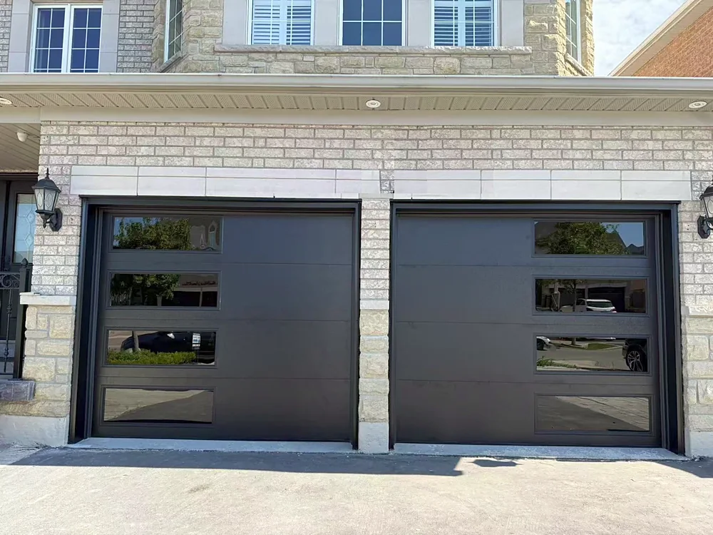 Black modern flush garage doors with windows on a home in Vaughan