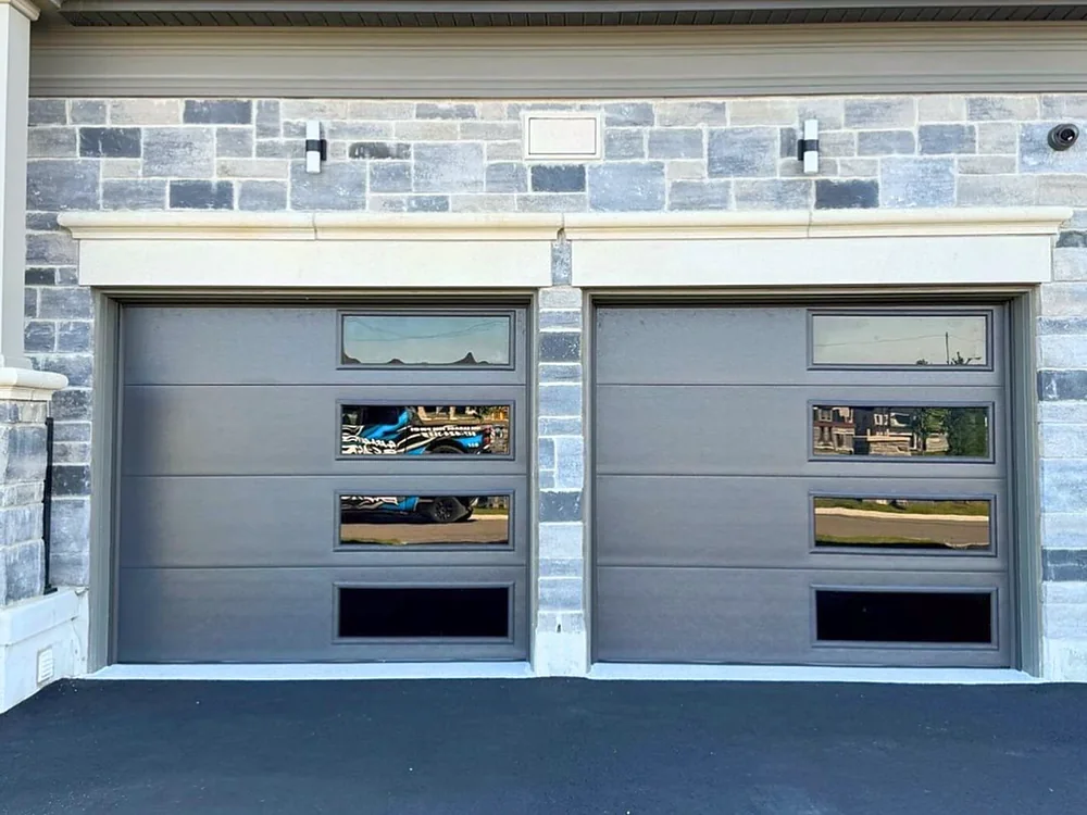 Dark brown modern flush garage doors with windows on a home in Woodbridge