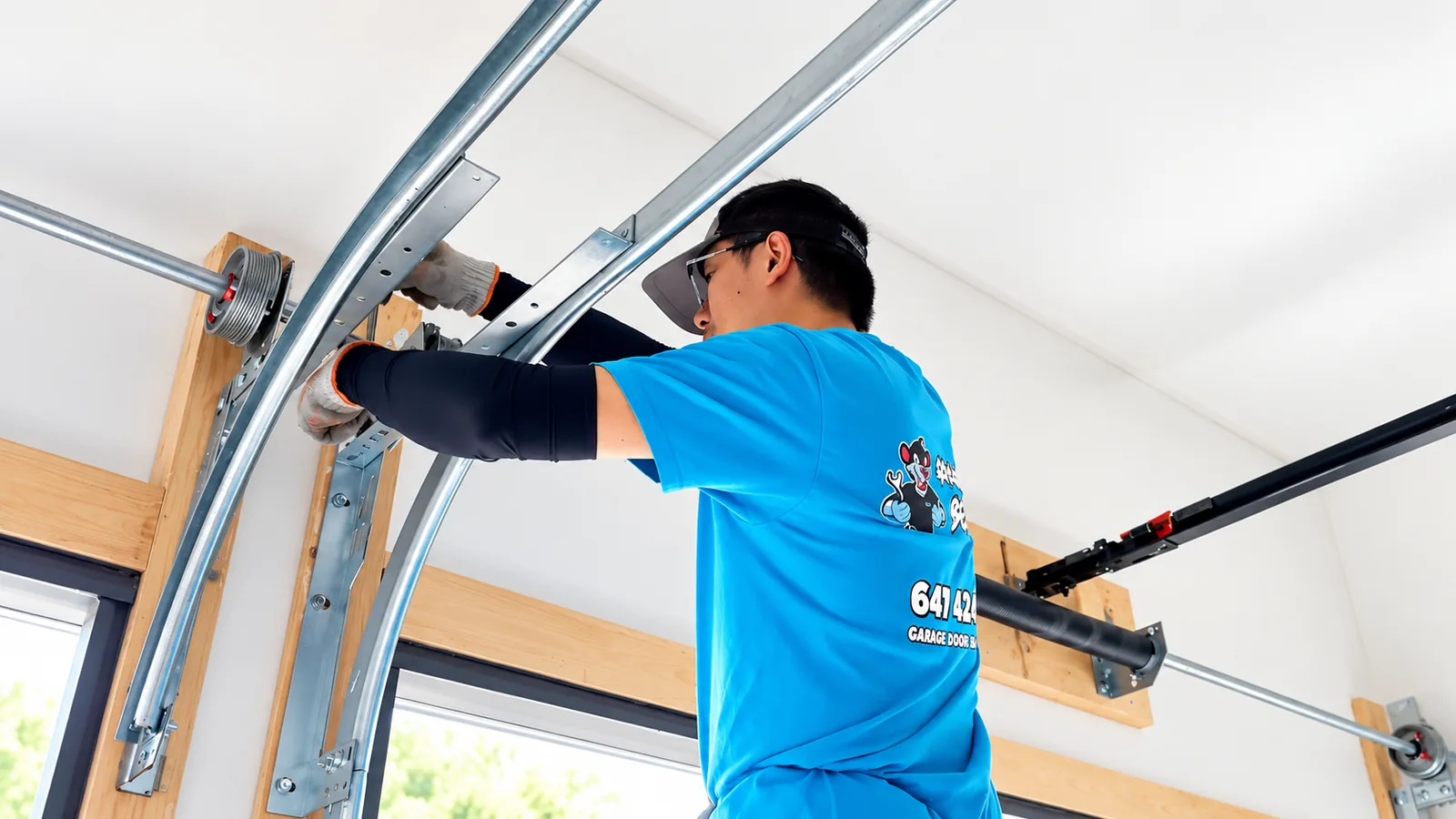 Garage Door Beasts technician installing new garage door tracks and hardware