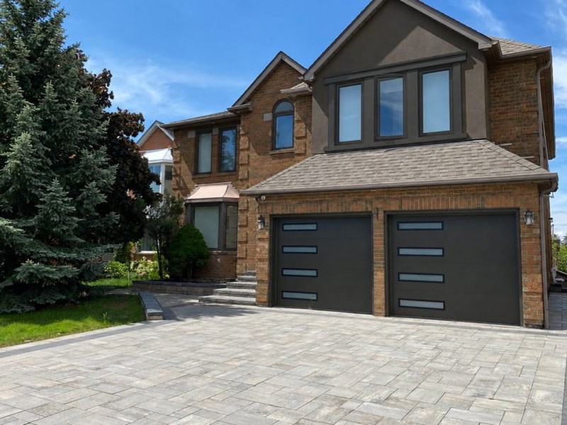 The same home after: modern black garage doors