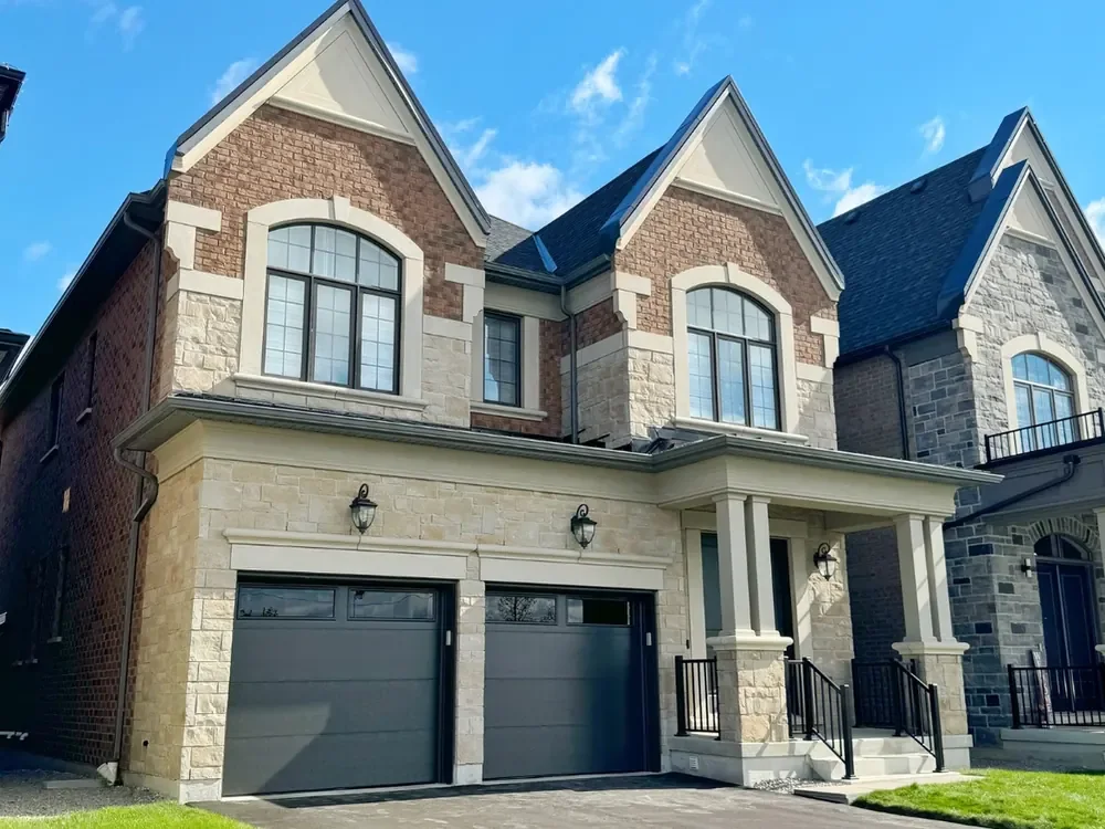 Black modern flush garage doors with windows on a home in Vaughan