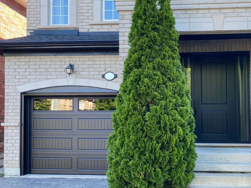 Black carriage-house garage door with windows on a home in Vaughan