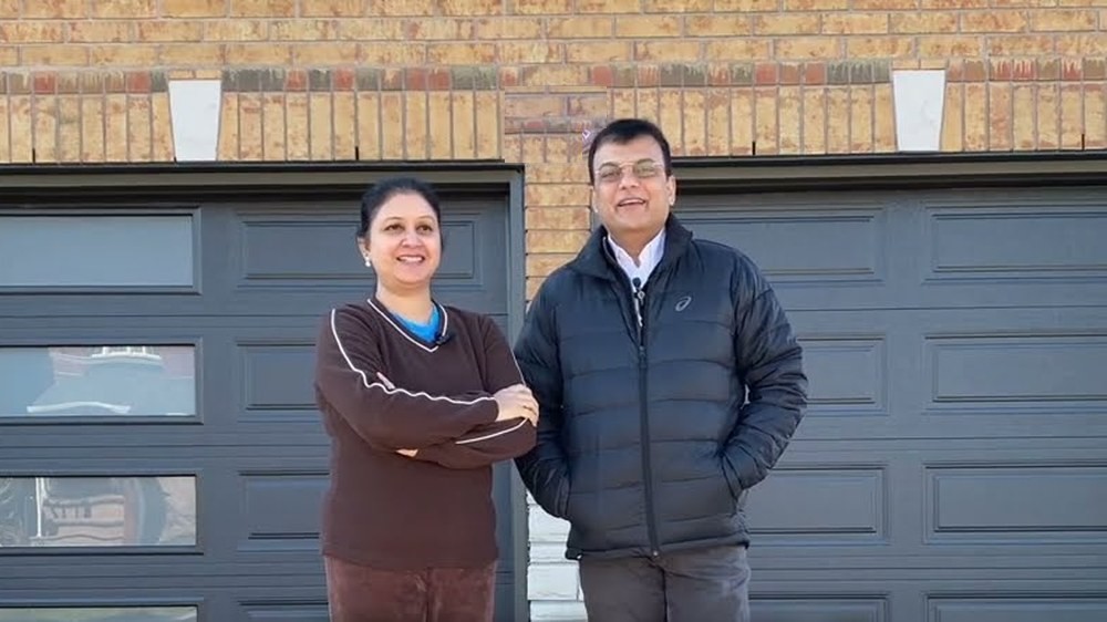 Garage Door Beasts customers outside their new double garage doors in Mississauga