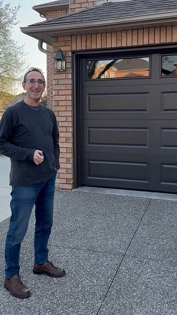 Garage Door Beasts customer outside his new garage door in Newmarket