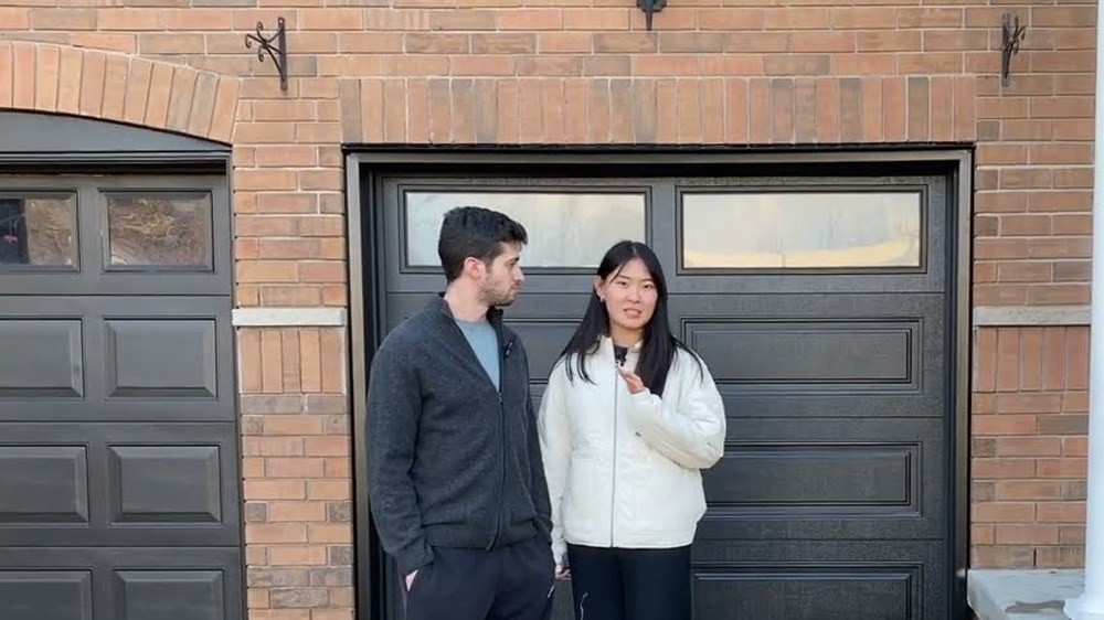 Garage Door Beasts customers outside their new black garage door in Vaughan